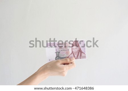 woman Hand holding korean money on wall background