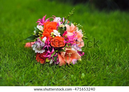 picture of a wedding bouquet , Wedding bouquet of pink and white roses lying on grass