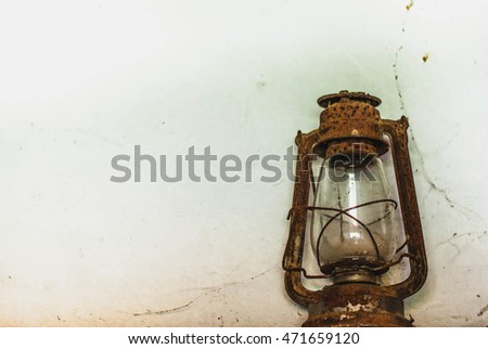 Old dirty kerosene lamp, which is no longer used, photo with noise
