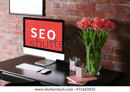 SEO technology concept. Modern workplace interior.