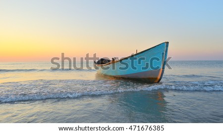 Fishing boat and sunrise on Black Sea Royalty-Free Stock Photo #471676385