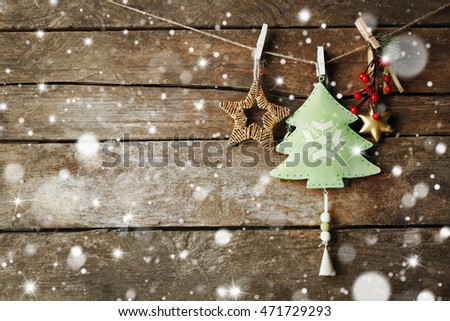 Beautiful Christmas toys on old wooden background. Snow effect