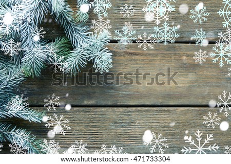 Christmas tree with frost on old wooden table. Snow effect