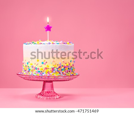 Colorful Birthday cake with sprinkles on a pink background. Royalty-Free Stock Photo #471751469