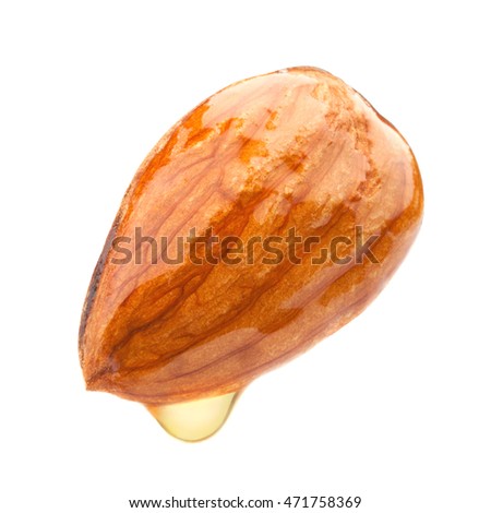 Golden almond oil drop Royalty-Free Stock Photo #471758369