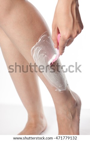 one Caucasian girl shaves legs women's refillable razor with shaving cream on a white background