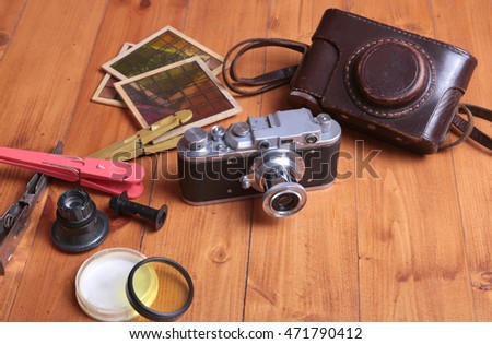 Vintage camera and accesoriess on wooden background