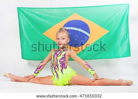 Girl doing rhythmic gymnastics element, split. Compete in individual events. Brazilian flag at the white background. Brazil fan support. Gymnastics program