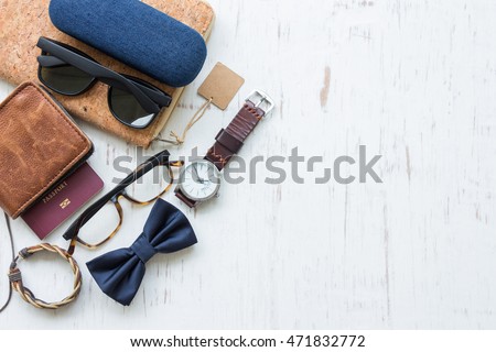 Flat lay, top view, men's accessories and essential travel items with space for text or object on white rustic wooden background Royalty-Free Stock Photo #471832772