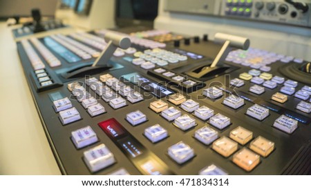 Video switcher of Television Broadcast with blurry background, working with video and audio mixer, CONTROL broadcasts in recording studio