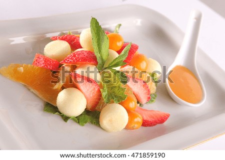 fruit and Berry salad with sweet sauce on plate