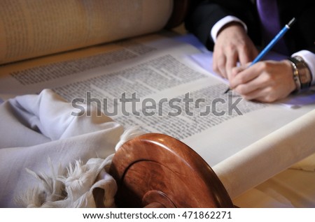 Sofer finishing the final letters of a sefer Torah. In the Torah's 613 commandments, the second to last is that every Jew should write a Sefer Torah in their lifetime. Royalty-Free Stock Photo #471862271