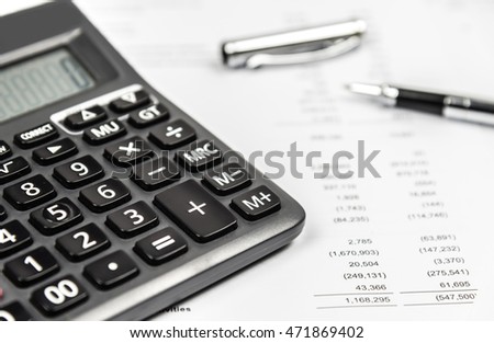 Calculator and pen on financial statement paper. Business accounting concept.