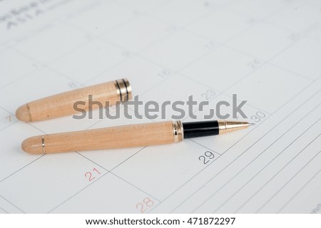 sheet of a calendar and a pen close-up