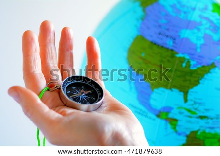 Hand holding a compass with North America on a globe in the background. Travel destination concept to Canada United Stats of America, Mexico and Latin America. No people. Copy space


















