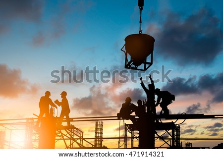 Silhouette engineer control standards and agreed business contract over blurred natural background sunset pastel. Heavy industry and safety at work concept.