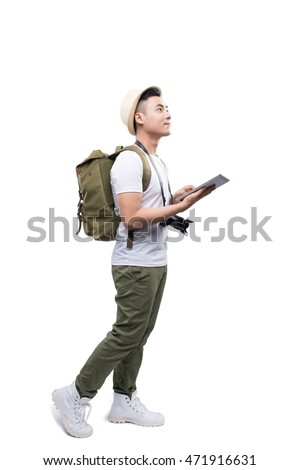 Full length portrait of happy tourist man using tablet on white background