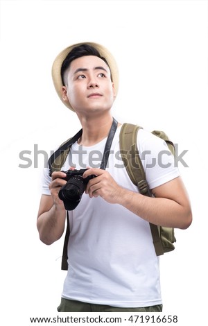 Travel concept. Studio portrait of handsome young man in hat with backpack. Isolated on white.