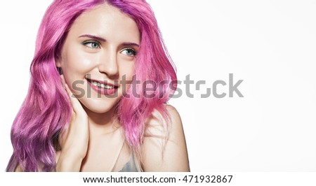 Close-up portrait of a smiling beautiful girl with colorful hair on white background with free space on the right
