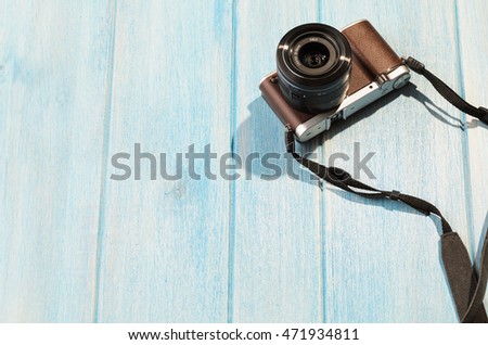 top view of retro style camera on blue wooden table Royalty-Free Stock Photo #471934811