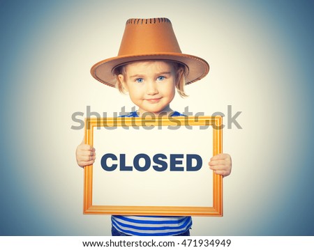 Little Funny girl in striped shirt with blackboard. Text CLOSED. Isolated on background.