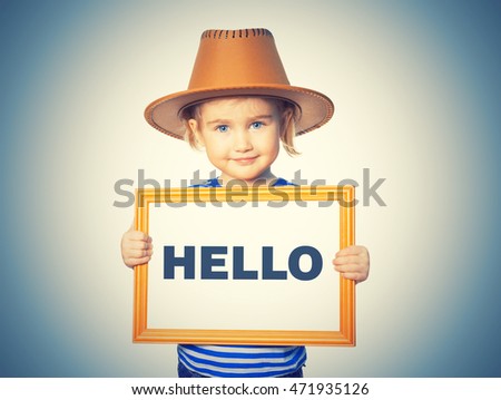 Little Funny girl in striped shirt with blackboard. Text HELLO. Isolated on  background.