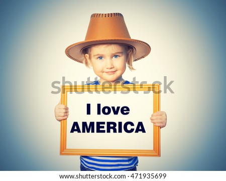 Little Funny girl in striped shirt with blackboard. Text I love AMERICA.  Isolated on background.