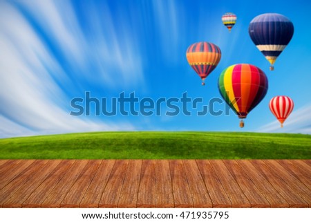 Wood table top on hot air balloons background - can used for display or montage your products
