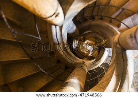 Medieval sandstone staircase shooted from bottom to up resembling double helical structure of DNA. Architecture graphical photography using creative tilt effect by tilt-shift lens.