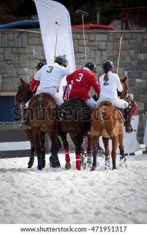 polo training - three polo riders on horses training snow polo