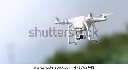 Flying drone in action; photographed on a defocused background. Royalty free image, no logos in the photo.