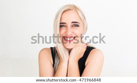 Widely smiling at camera pretty blonde. Lovely woman with strange smile hugging her neck and laughing, Happiness, fun, frivolity