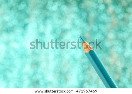 Blue color pencil on blue bokeh background.