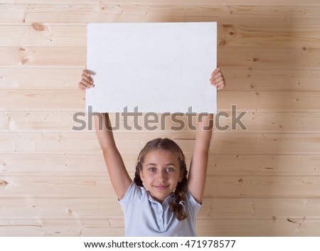 Little girl holding blank white board