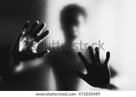 Ghosts hand silhouette behind the glass 