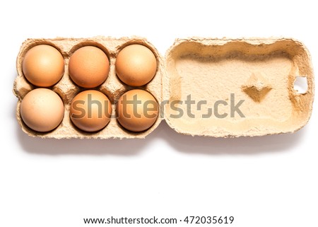 View of opened box of six brown chicken eggs for market place or shop isolated on white background. Package of six raw chicken eggs for meal or other health food.
