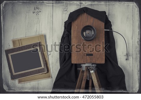 The old studio camera and two old photos.The stylized photo