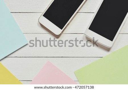 Smartphone on white table background. Vintage tone. 