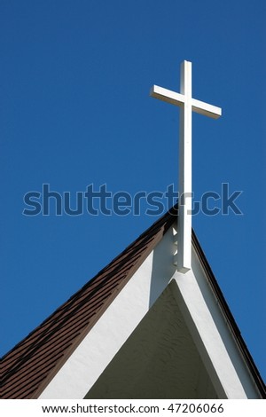 Christian religious image of a cross on top of a church with copy space