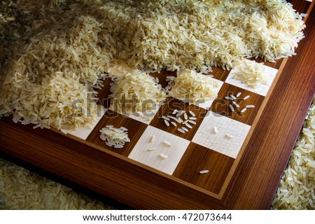 chessboard with exponential growing heaps of rice grains, legendary metaphor of unlimited growth Royalty-Free Stock Photo #472073644