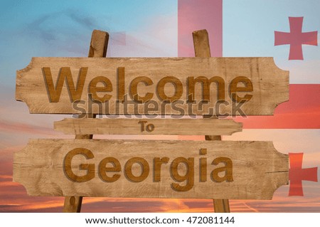 Welcome to Georgia sing on wood background with blending national flag