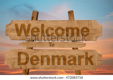 Welcome to Denmark sing on wood background