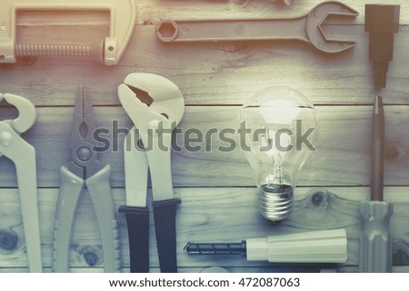 tools and instruments toys with light bulb on wood texture creativity ideas concept with copy space four yourtext with vintage color tone
