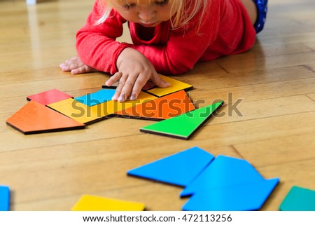 little girl playing with puzzle, early education