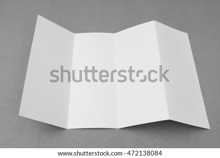 Four - fold white template paper on gray  background