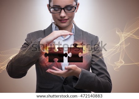 Businesswoman in business concept with puzzle piece