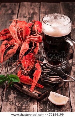 boiled crayfish and beer on a wooden background