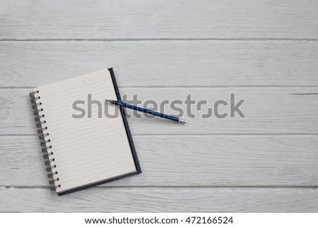 Blank notebook with pencil on table background copy space