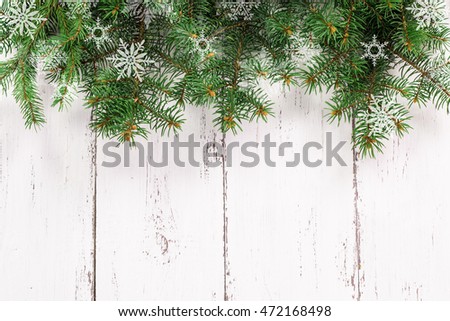 Old wood texture with snow and fir tree christmas background