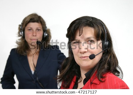 Young friendly brunette woman with headset smiling during conversation